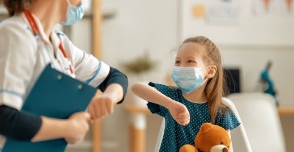 Doctor and child wearing facemasks